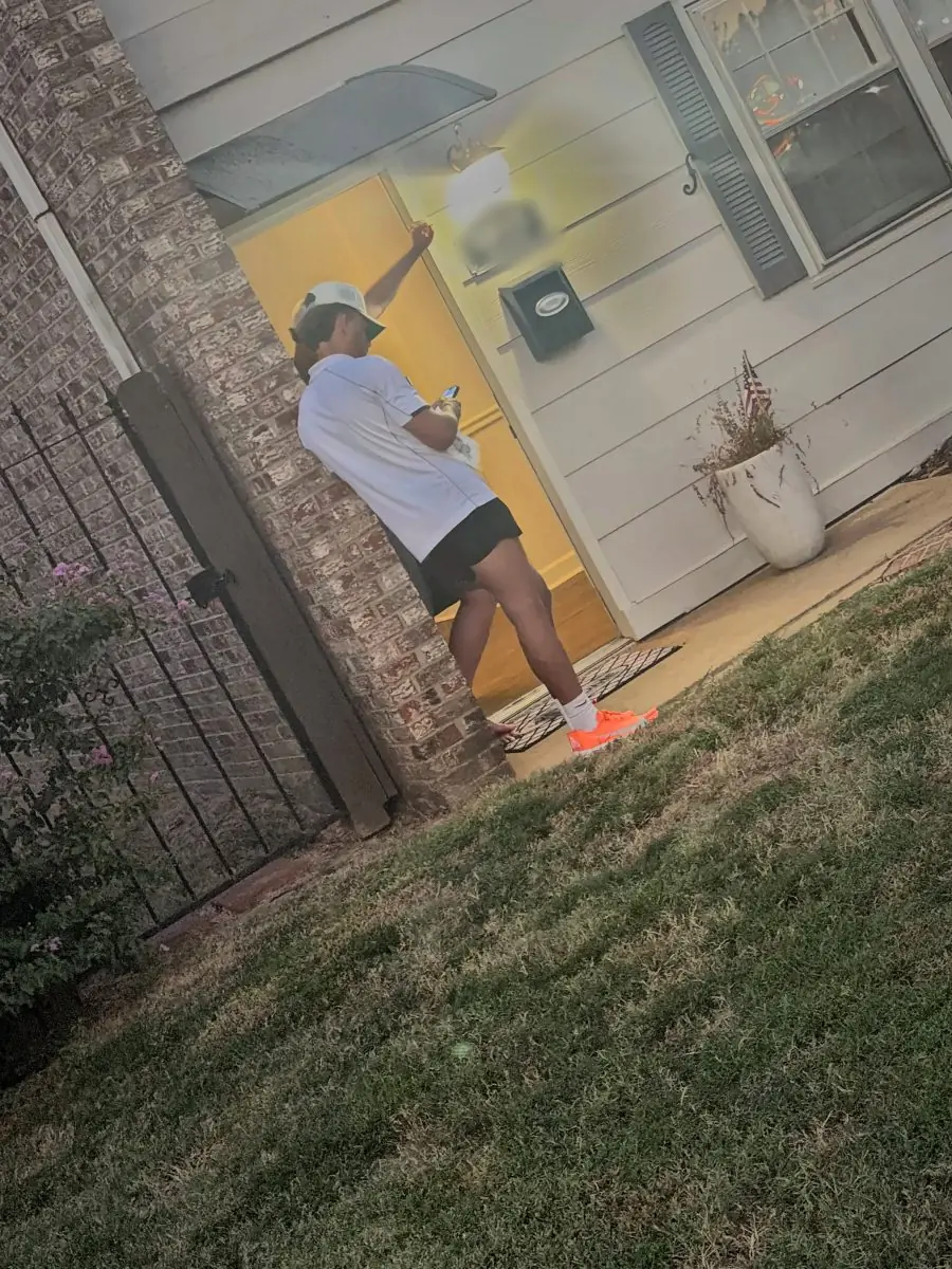 A rep knocking at a front door at dusk